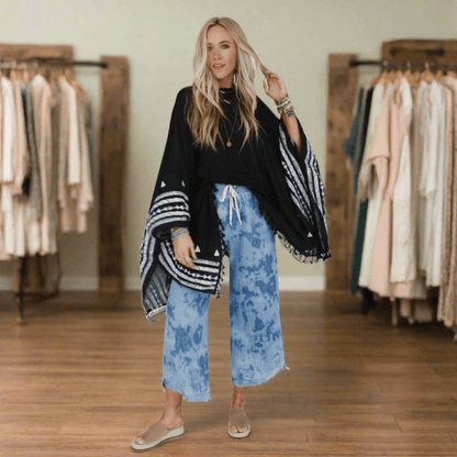 Comfortable black tassel poncho for casual wear
Versatile women's poncho with embroidery and tassels
Embroidered tassel poncho for fall outfits
Elegant black poncho for women with embroidery
Black tassel poncho top for layering
Women's casual embroidered poncho with sleeves
Bohemian black poncho top with tassel accents